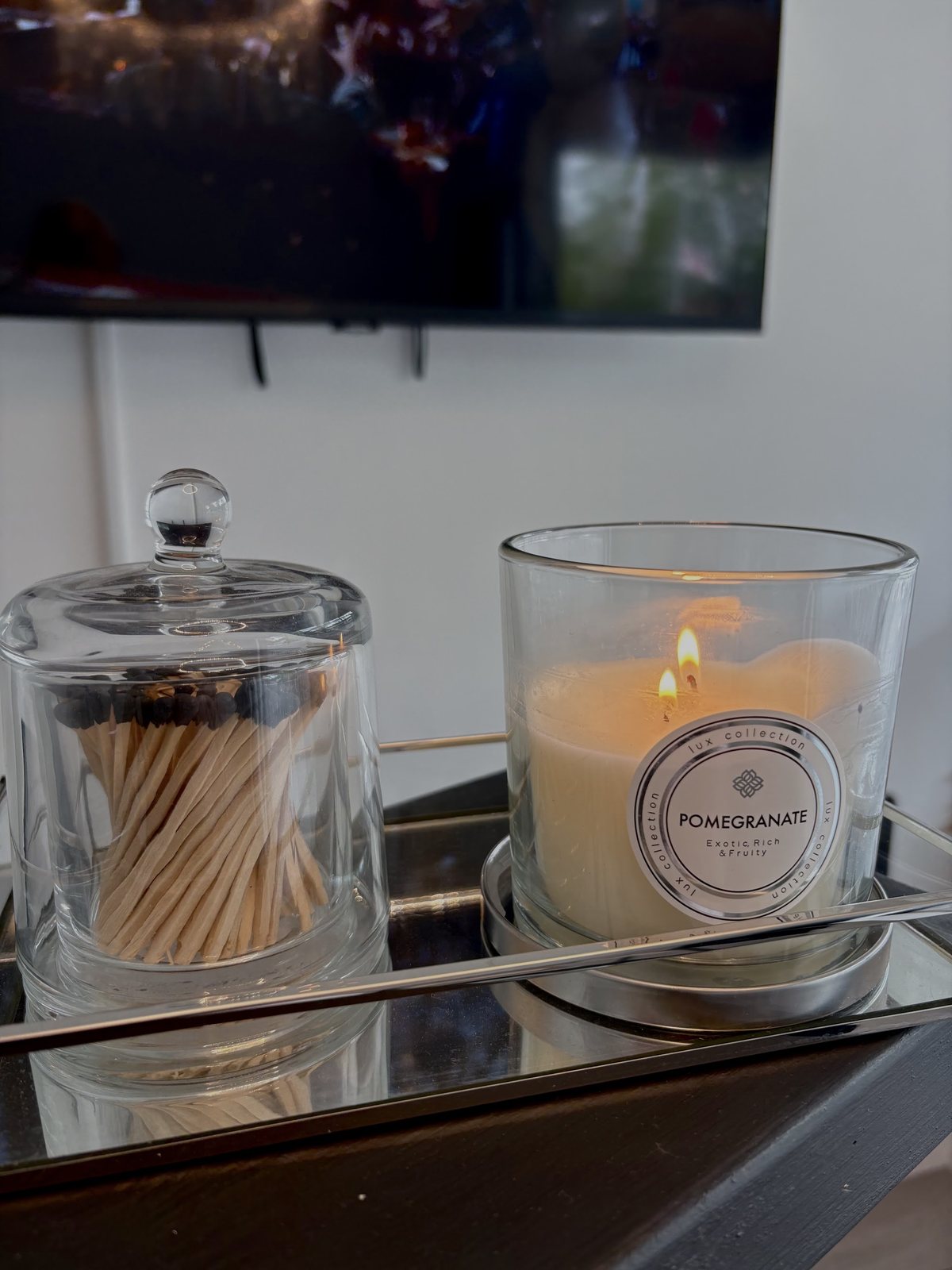 A lit candle and matches on a mirrored tray in the clinic